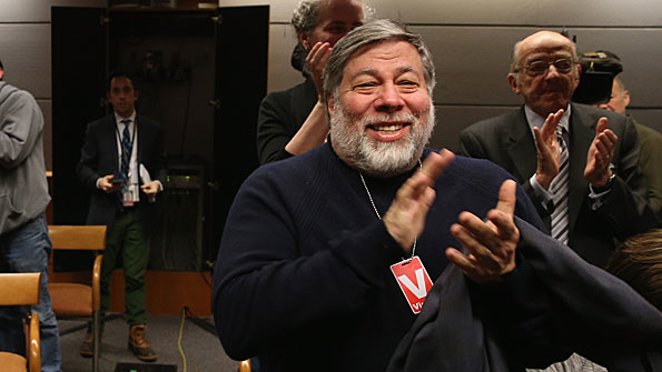 Apple CoFounder Steve Wozniak applauds after the FCC voted to approve Net Neutrality during a hearing at the FCC headquarters February 26 2015 in Washington DC