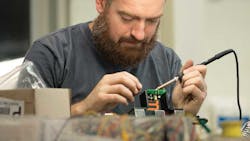 Tim Gillespie electronics community manager solders control boards in the FirstBuild lab where community members come together to build prototypes of next generation appliances Tim Gillespie electronics community manager solders control boards in the FirstBuild lab where community members come together to build prototypes of next generation appliances