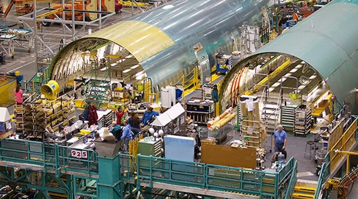 Boeing employees work on Boeing 777 passenger plane fuselage section on one of the assembly lines at the company&apos;s factory in Everett, Wash.