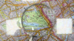 A map of London with a magnifying glass focused on Hyde Park A map of London with a magnifying glass focused on Hyde Park