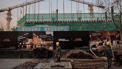 Workers at a site in Beijing Workers at a site in Beijing