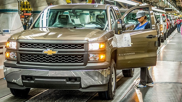 An employee at GM39s Fort Wayne Assembly plant inspects a Chevrolet Silverado as it comes off the assembly line