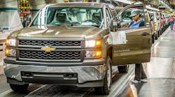 An employee at GM&apos;s Fort Wayne Assembly plant inspects a Chevrolet Silverado as it comes off the assembly line.