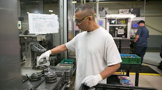 A worker assembles cam phasers at GM&apos;s Grand Rapids Operations plant.