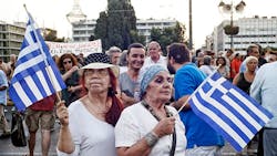 Protesters wave Greece flags in favor of the country Protesters wave Greece flags in favor of the country