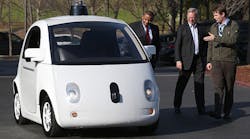 Chris Urmson, right, the head of Google&apos;s self-driving car project, shows the product to U.S. Transportation Secretary Anthony Foxx, left, and Google chairman Eric Schmidt at the company&apos;s headquarters in Mountain View, Calif.