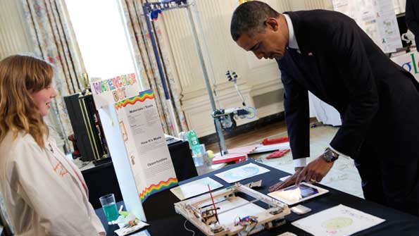President Obama looks at a paint robot created by Sylvia Todd of Auburn Calif during the 2013 White House Science Fair The annual event recognizes student achievements in science technology engineering and math competitions from across the US