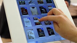 An Apple customer browses ebooks on an iPad An Apple customer browses ebooks on an iPad