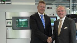 Pascal Boillat, left, the head of manufacturing solutions for GF, poses with EOS founder and CEO Dr. Hans Langer in front of an EOS M 290 metal additive manufacturing system.