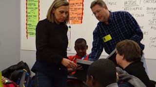 Students at Fisher Middle School in South Carolina work on a project with mentors from Sage Automotive Interiors, one of 12 companies involved in a collaborative mentorship program with the school.