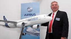 Airbus COO and CCO John Leahy shows off a model of an A320 during the 2012 Internationale Luftausstellung Air Show in Berlin.