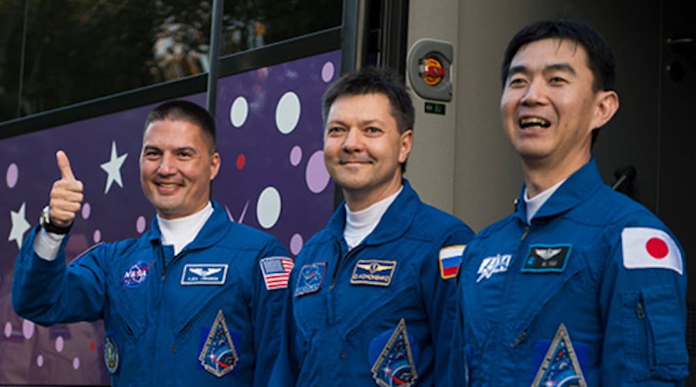 Soyuz flight engineer and NASA astronaut Kjell Lindgren, left, Soyuz commander and Roscosmos cosmonaut Oleg Kononenko, center, and flight engineer and JAXA astronuat Kimiya Yui bid farewell Wednesday before final preparations for their flight to the International Space Station. The crew reached the ISS after an almost six-hour trip.