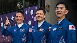 Soyuz flight engineer and NASA astronaut Kjell Lindgren, left, Soyuz commander and Roscosmos cosmonaut Oleg Kononenko, center, and flight engineer and JAXA astronuat Kimiya Yui bid farewell Wednesday before final preparations for their flight to the International Space Station. The crew reached the ISS after an almost six-hour trip.