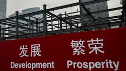 A banner at a Chinese construction site reads Development Prosperity A banner at a Chinese construction site reads Development Prosperity
