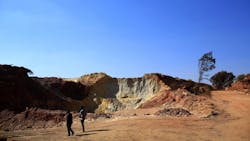 Two men walk through a mine dump in Johannesburg South Africa Two men walk through a mine dump in Johannesburg South Africa
