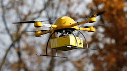 A quadcopter drone arrives with a small delivery in Bonn Germany A quadcopter drone arrives with a small delivery in Bonn Germany