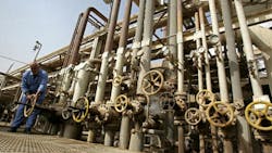 An Iraqi worker adjusts control valves at the Daura oil refinery An Iraqi worker adjusts control valves at the Daura oil refinery