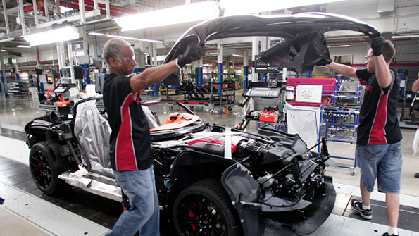Workers lower a hood on a Dodge Viper at the Viper Assembly Plant in Detroit