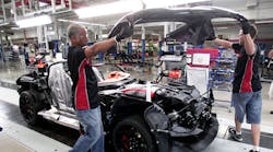 Workers lower a hood on a Dodge Viper at the Viper Assembly Plant in Detroit. The plant manufactures three cars per day, a small percentage of the more than 1.5 million reported vehicles sold in July.