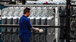 A Ford factory worker on the assembly line A Ford factory worker on the assembly line