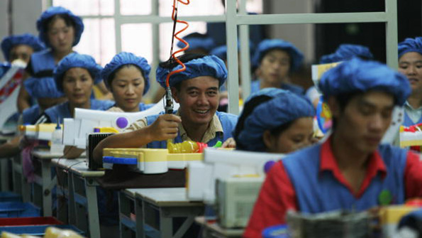 Workers assemble toy cars in a Chinese factory