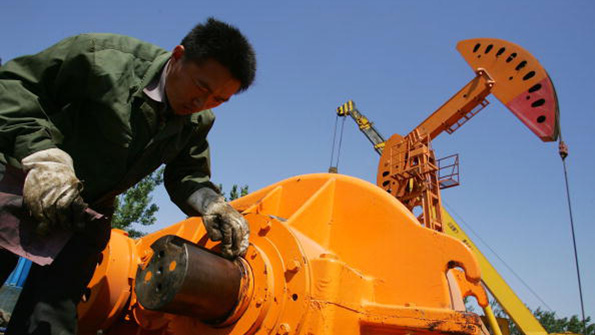 A laborer repairs an oilpumping unit