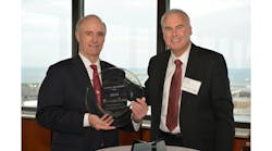 Keith Nosbusch, chairman and CEO, Rockwell Automation, accepts the 2014 North America Procurement Supplier of the Year award for technical procurement - maintenance, repair and operations (MRO) from Andy Murray, head of technical procurement, Nestle.