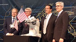 ABB CEO Ulrich Spiesshofer, far right, and other company executives introduce a new robotics factory in suburban Detroit in May. Spiesshofer announced Wednesday that the company will aim to save $1 billion.