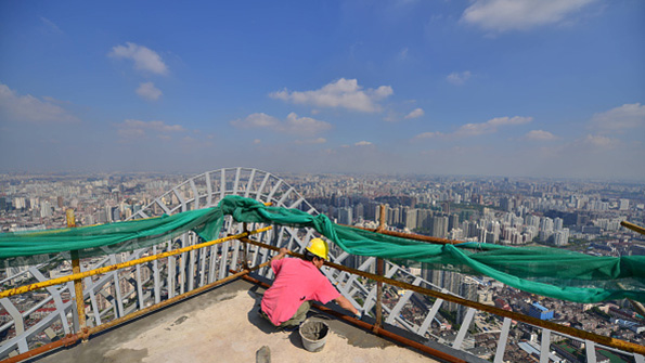 A worker on the top of a Shanghai tower