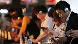 Tokyo Game Show attendees play with handheld consoles Tokyo Game Show attendees play with handheld consoles