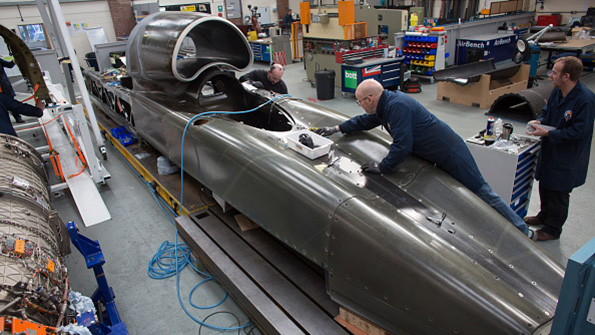 Engineers work on the carbonfiber body of the Bloodhound SSC