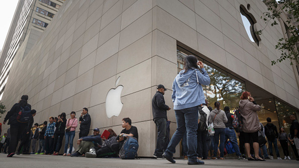 Apple customers and fans wait in line