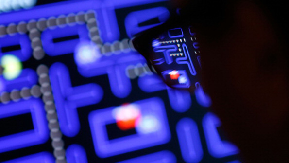 A video game player dives into PacMan