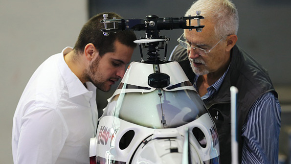 Two attendees view an Unmanned Aerial Vehicle model at the Aviation Expo China