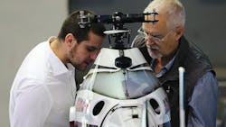 Two attendees view an Unmanned Aerial Vehicle model at the Aviation Expo China Two attendees view an Unmanned Aerial Vehicle model at the Aviation Expo China