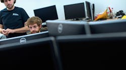 Virginia Tech mechanical engineering grad students check computer code on desktops on campus. Personal computer sales are down almost 8% from last year.