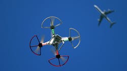 A recreational drone flies beneath a commercial airliner A recreational drone flies beneath a commercial airliner