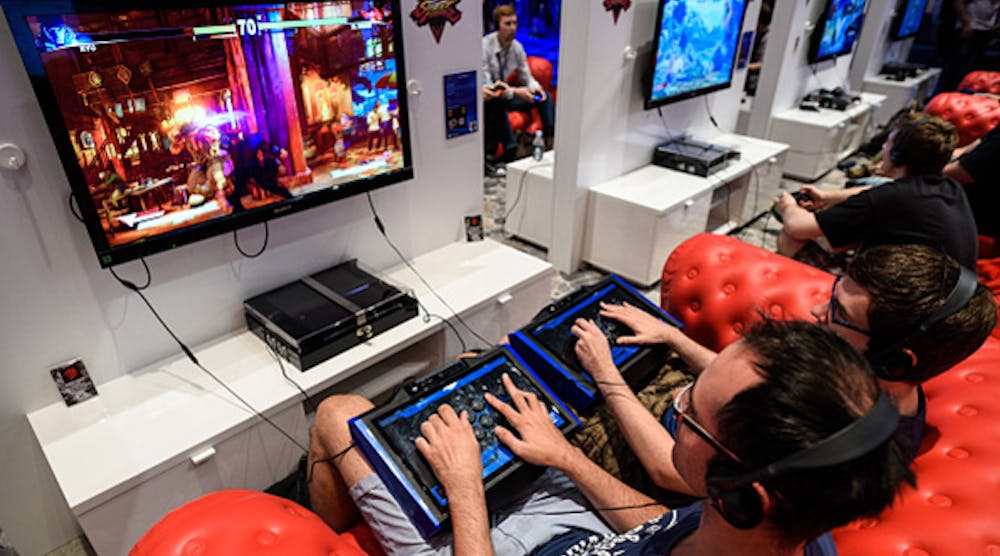 Video gamers play the latest from Sony Playstation 4 at Gamescon 2015 in Cologne, Germany. Sony reported a six-month profit of almost $1 billion a day after announcing a planned acquisition of Toshiba&apos;s image sensor business.