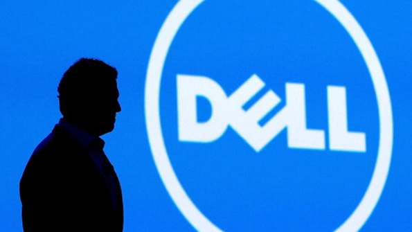 Dell CEO Michael Dell stands in front of his companys logo