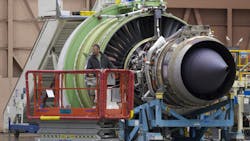 A Boeing employee checks out a GE Avition engine for a 777 A Boeing employee checks out a GE Avition engine for a 777