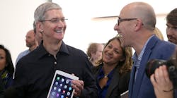 Apple CEO Tim Cook meets with reporters and fans at an Apple store event. The company will add as many as 1,000 jobs at its European headquarters in Cork, Ireland.