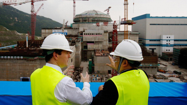 British and Chinese officials tour a new plant in Taishan