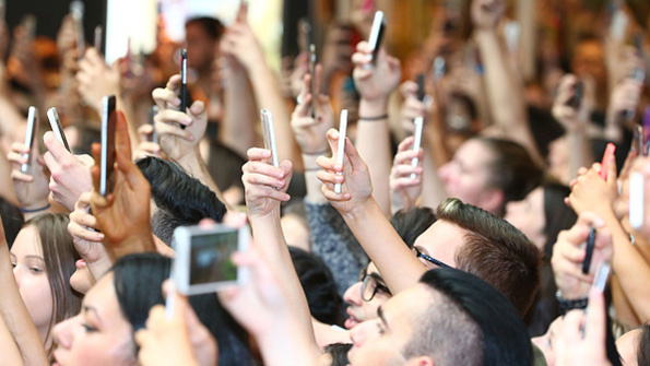 People snap an image with smartphone cameras