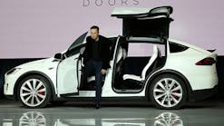 Tesla Motors CEO Elon Musk emerges from the new Model X during the vehicle&apos;s launch event in late September. More than 20,000 orders have already come in for the Model X, which starts at $80,000.