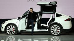 Tesla Motors CEO Elon Musk emerges from the new Model X during the vehicle&apos;s launch event in late September. More than 20,000 orders have already come in for the Model X, which starts at $80,000.