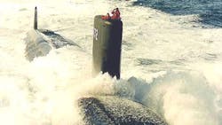 Crew members man the sail as the USS Greenville surfaces Crew members man the sail as the USS Greenville surfaces