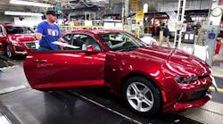 A worker puts the finishing touches on a 2016 Chevrolet Camaro at GM&apos;s Lansing Grand River assembly plant.