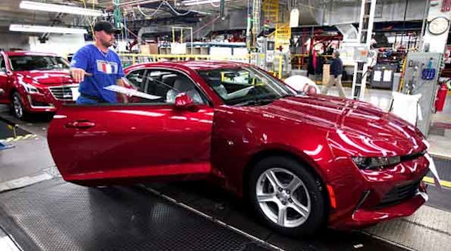 A worker puts the finishing touches on a 2016 Chevrolet Camaro at GM&apos;s Lansing Grand River assembly plant.