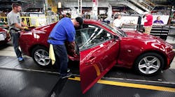 General Motors workers polish off another 2016 Chevrolet Camaro at the Lansing, Mich., plant. The economy added 211,000 new jobs in November, according to the Labor Department.
