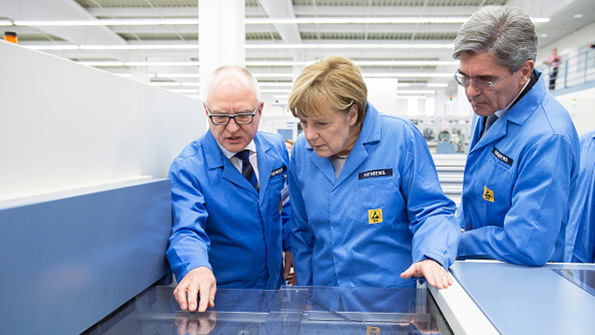Siemens CEO Joe Kaeser right German Chancellor Angela Merkel center